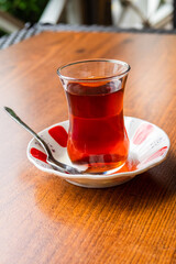 turkish tea in small glass on saucer close up