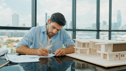 Portrait of caucasian architect engineer designs real estate on blueprint. Professional engineer...