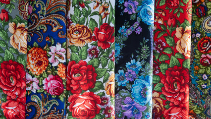 several colorful traditional Polish pattern fabric scarfs with floral pattern in seamless background