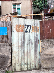 shabby gate of urban house on street in Tbilisi