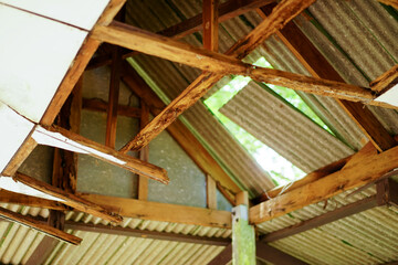 The damaged wooden roof structure of the pavilion. Home renovation or repair concept.