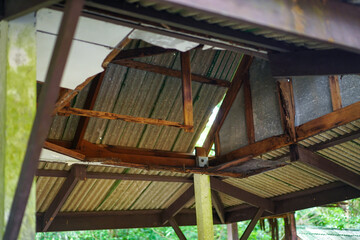 The damaged wooden roof structure of the pavilion. Home renovation or repair concept.