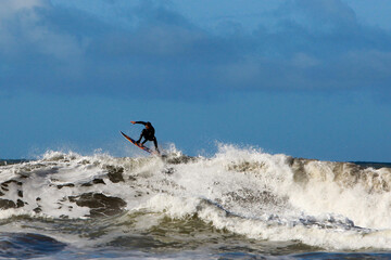 a surfer in the ocean riding a wave on a sunny summer day 