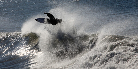 a surfer in the ocean riding a wave on a sunny summer day 