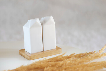 two salt shakers stand on a stand on the table