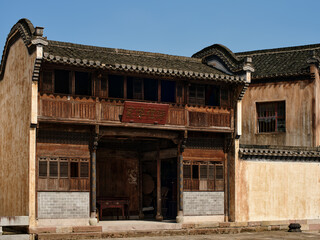 the brick wall and wooden facade of a traditional chinese style building