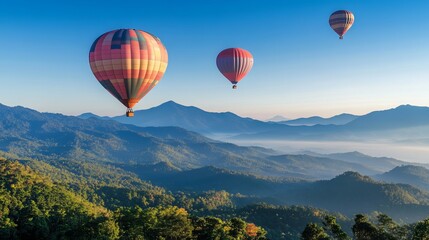 Naklejka premium Vibrant hot air balloons soar gracefully over the majestic mountain peaks of Dot Inthanon, casting an enchanting tapestry against the clear blue sky of Chiang Mai, Thailand. 