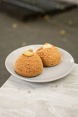 Choux au Craquelin french pastry or cream puff dessert on a plate