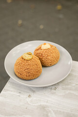 Choux au Craquelin french pastry or cream puff dessert on a plate