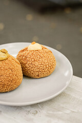 Choux au Craquelin french pastry or cream puff dessert on a plate