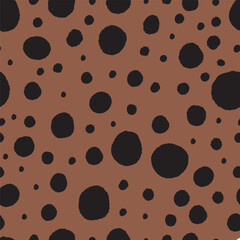 Set of hand drawn dots patterns. Black spots on brown background. Big and small blobs.