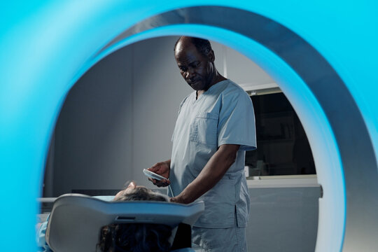 Medical professional assisting patient in advanced healthcare environment with modern equipment and technology