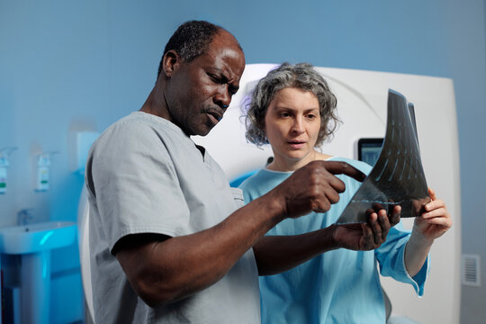 Healthcare professionals analyzing medical scan results with focus on patient care and accurate diagnosis