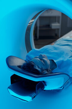 Patient lying under MRI machine in radiology room feeling calm with modern technology