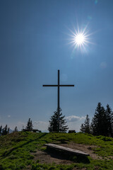 summit cross on the top of the mountain against the sun