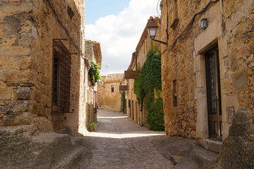 Peratallada, historic centre with small alleys and medieval Romanesque buildings at at a sunny day with blue sky, Pals, Begur, Girona, Catalonia, Costa Brava, Spain