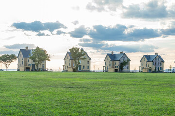 Obraz premium A beautiful sunset is captured surrounding the historic architecture of the buildings at Fort Hancock in Sandy Hook, New Jersey. Photo taken in August of 2024.