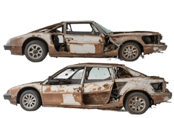 An abandoned rusted car isolated on white background with clipping path.