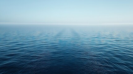 Fototapeta premium A clear water body with sunlight filtering through the clouds, casting a deep blue hue on the surface