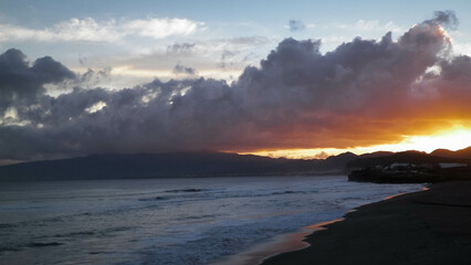 Obraz premium Beautiful sunset over beach in Ribiera Grande, Atlantic Ocean, Azores Islands.