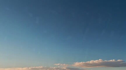 Obraz premium The sky stretches overhead, adorned with fluffy cumulus clouds that float like cotton candy against a vibrant blue canvas. AI generated.