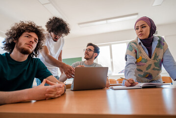 A group of diverse college students studying together or a business team working together on a project plan in the office workplace.