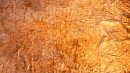 Abstract textured background created by rough natural stone surface, adding a warm and earthy feel