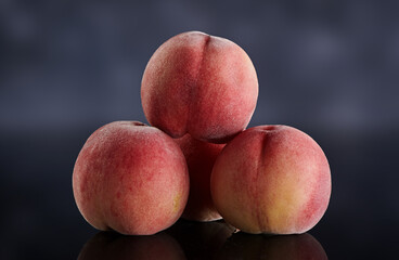 Fresh peaches on dark background