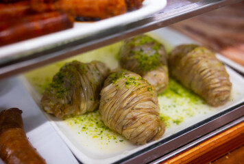 Traditional Spanish dish from Aragon, madejas, on counter in cafe. Unprepared dish made lamb's...
