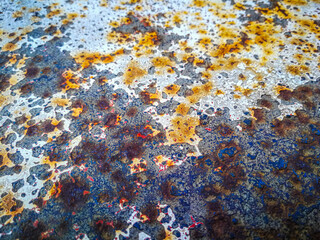 View on an old metal table painted white but then stripped and rusted over time