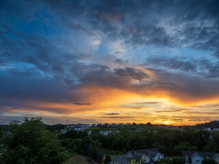 Stunningly colorful sunset over suburban houses on a summer evening in Pennsylvania, USA.