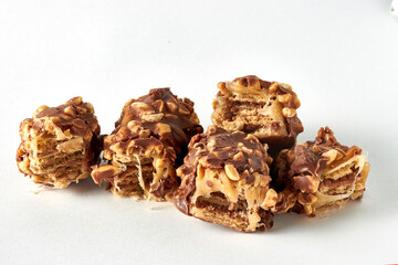 Wafer caramel bar with nuts and chocolate glaze broken into pieces