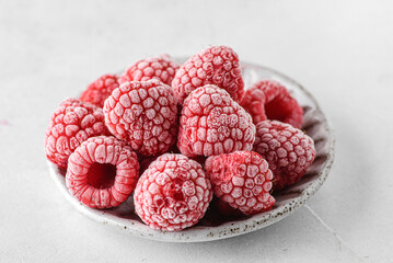 frozen raspberries in a grey bowl