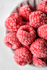 frozen raspberries in a grey bowl