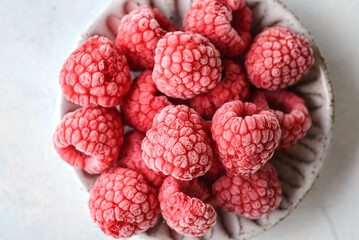 frozen raspberries in a grey bowl