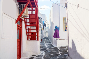 Mykonos island, Greece. Famous old town narrow street with white houses and red stairs
