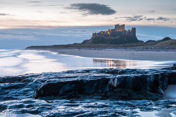 Bamburgh castle on the beach at sunrise