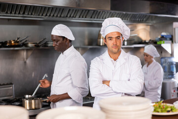 Portrait of confident chef with arms crossed in restaurant kitchen