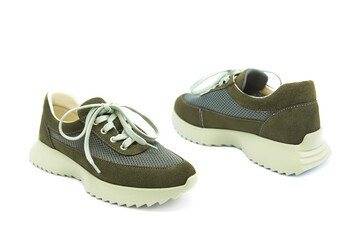 Sneakers. Pair of fashionable leather with suede inserts shoes isolated on white background. View from all sides.