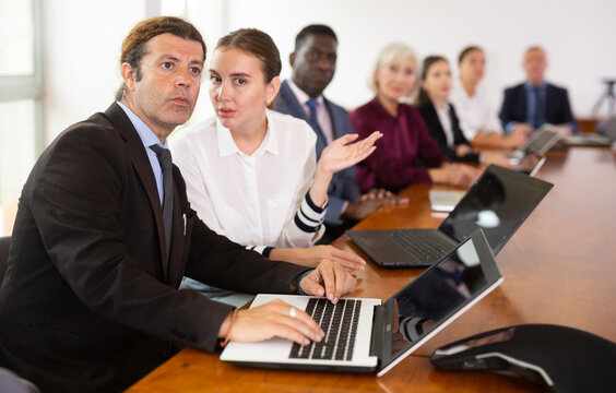 Young woman secretary chatting with her boss during meeting in conference room. - Powered by Adobe
