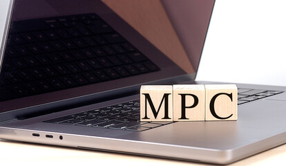 MPC word on wooden block on a laptop , business concept