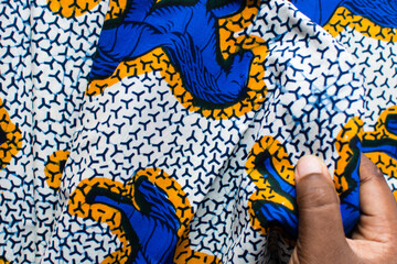 top view of blue and white ankara fabric, flatlay of nigerian wax cloth, rumpled blue and white ankara material