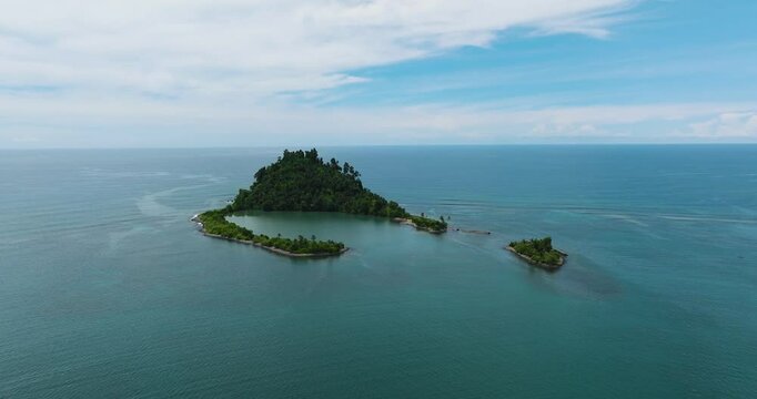 Air survey of Tropical island with a beach in the open ocean. Cabugao Island. Mindanao, Philippines.