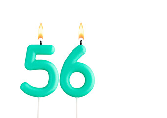 Green birthday candle on white background - Candle number 56