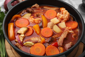Tasty homemade stew with vegetables on table, closeup