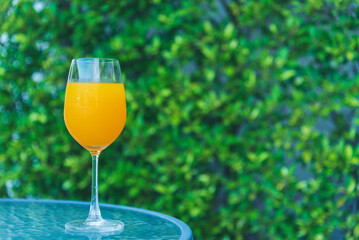 Orange juice cool drinks sweet freshness drinking poolside at blue swimming pool in tourist resort. Orange smoothie juicy healthy mocktail organic cool juice glass. Sweet healthy beverage cool drinks