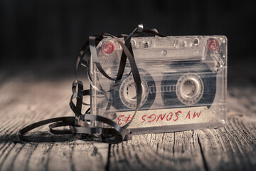 Classic and old one audio cassette with an extracted tape