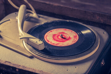 Old gramophone with few scratched vinyl records.