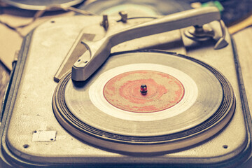 Vintage record player with few scratched vinyl records.