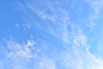 beautiful blue sky and white fluffy group of clouds with sunrise in the morning, natural background
